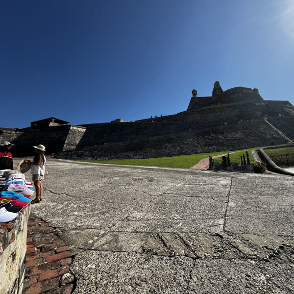 The San Felipe fortress in Cartagena under a blue sky, Colombian flag flying
